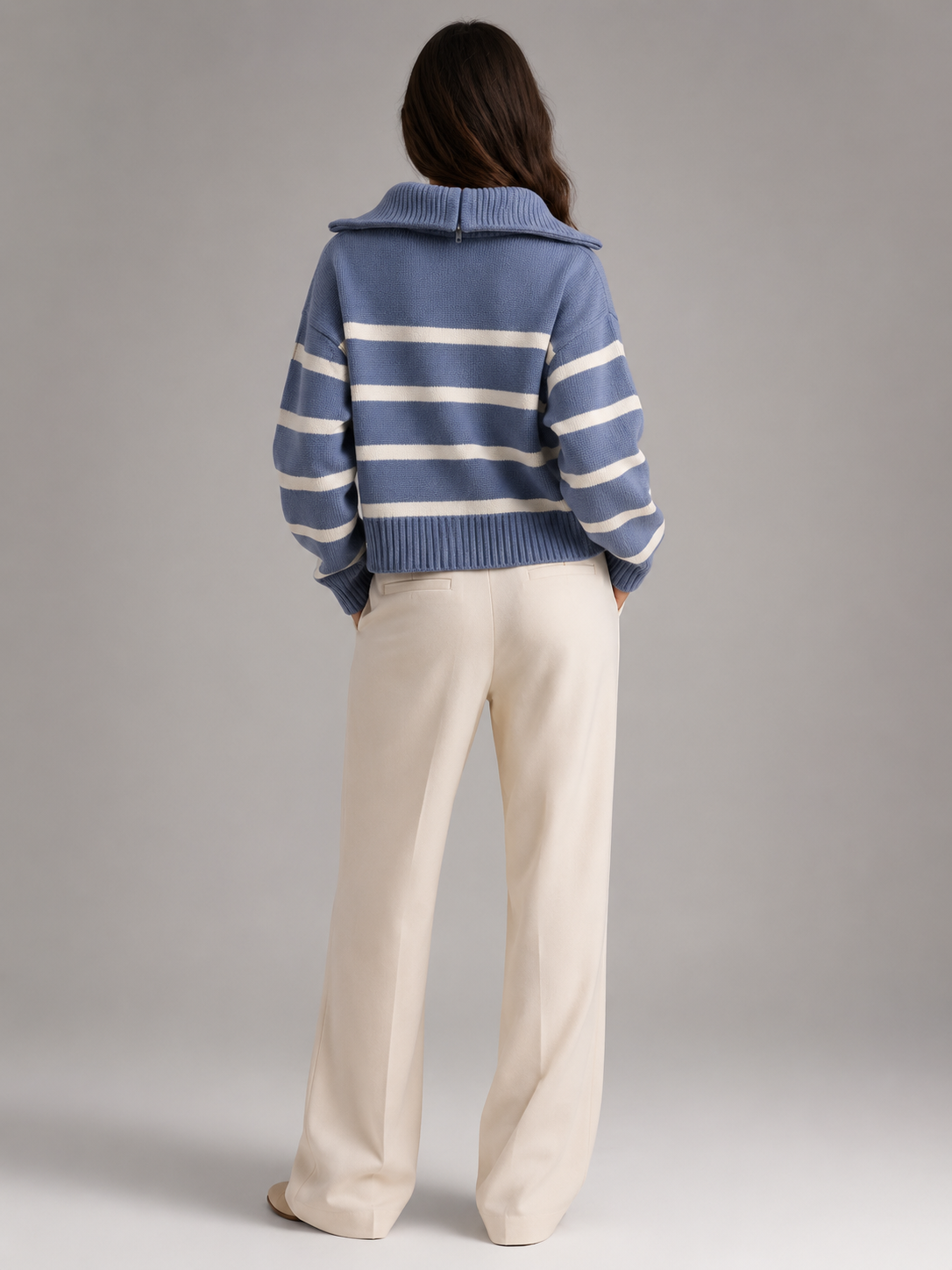 Blue and white striped half-zip sweater in mid-weight knit with a relaxed drop-shoulder fit and ribbed hem.