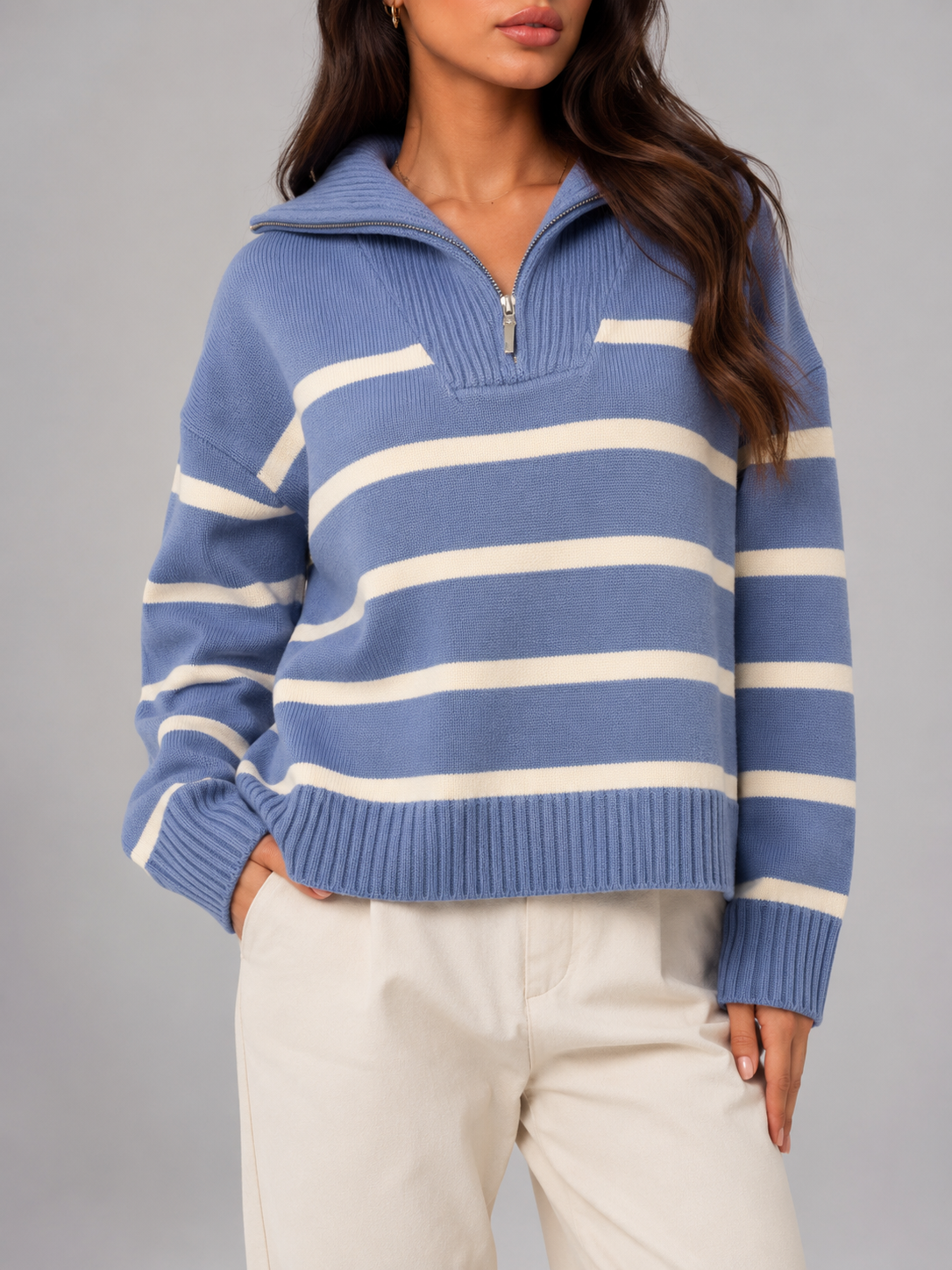 Blue and white striped mid-weight knit half-zip sweater with a relaxed drop-shoulder fit and ribbed hem.