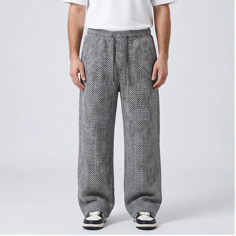 Gray herringbone tweed sweatpants in a wide-leg, high-waisted fit with an elastic drawstring waistband.
