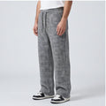 Men’s wide-leg tweed sweatpants in gray herringbone wool-blend with an elastic drawstring waist and full-length fit.