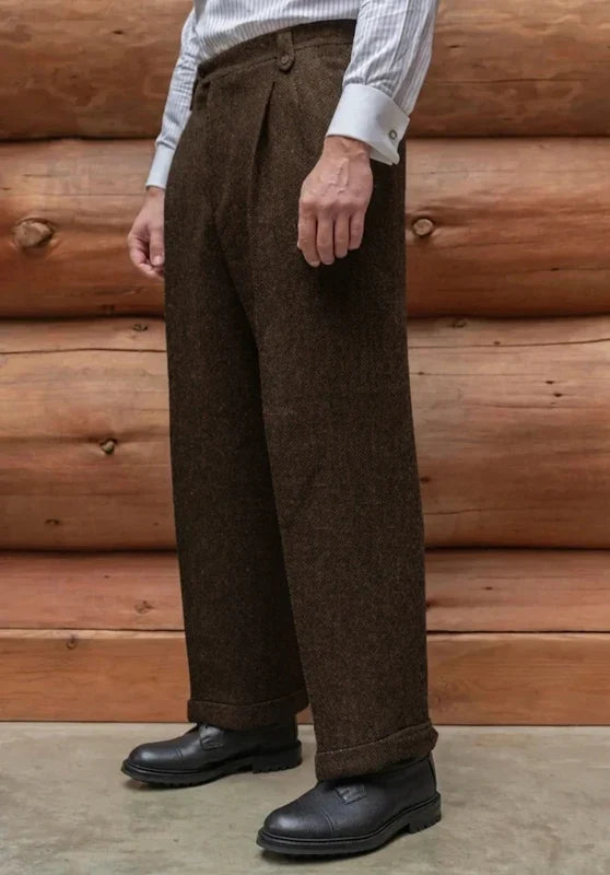Dark brown tweed wool trousers with a straight-leg fit, cuffed hems, and a flat front, styled with a striped dress shirt.