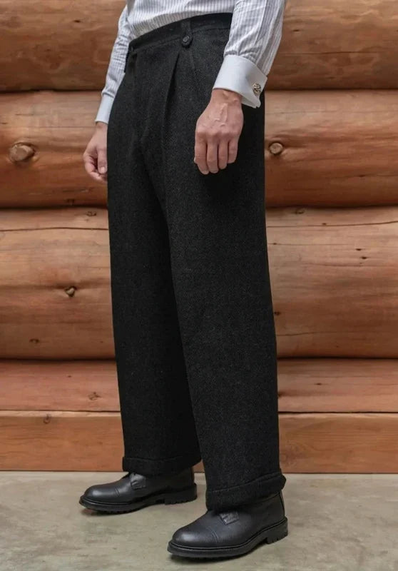 Black tweed wool trousers featuring a straight-leg silhouette, flat front, and cuffed hems.