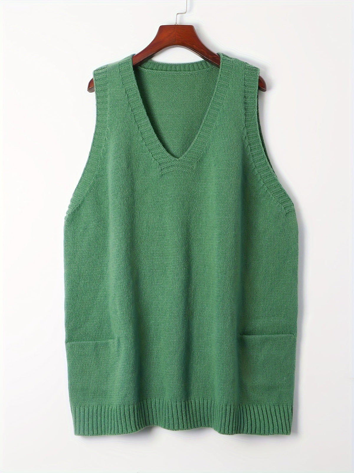 Front product hanging view of the fuzzy knit V-neck sweater vest in sage green featuring ribbed trim and front patch pockets.