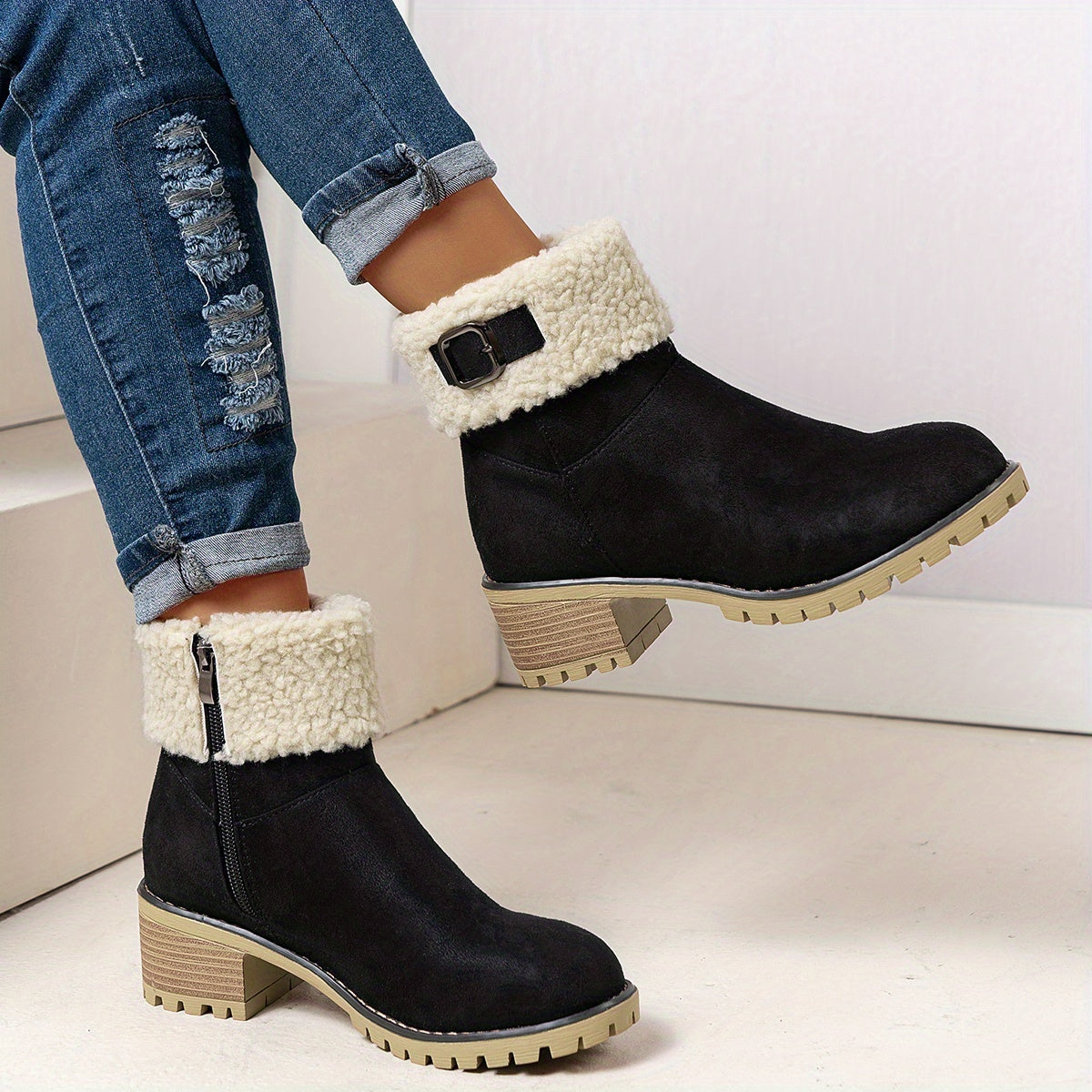 Black sherpa cuff ankle boots for women with stacked block heel, worn with cuffed jeans