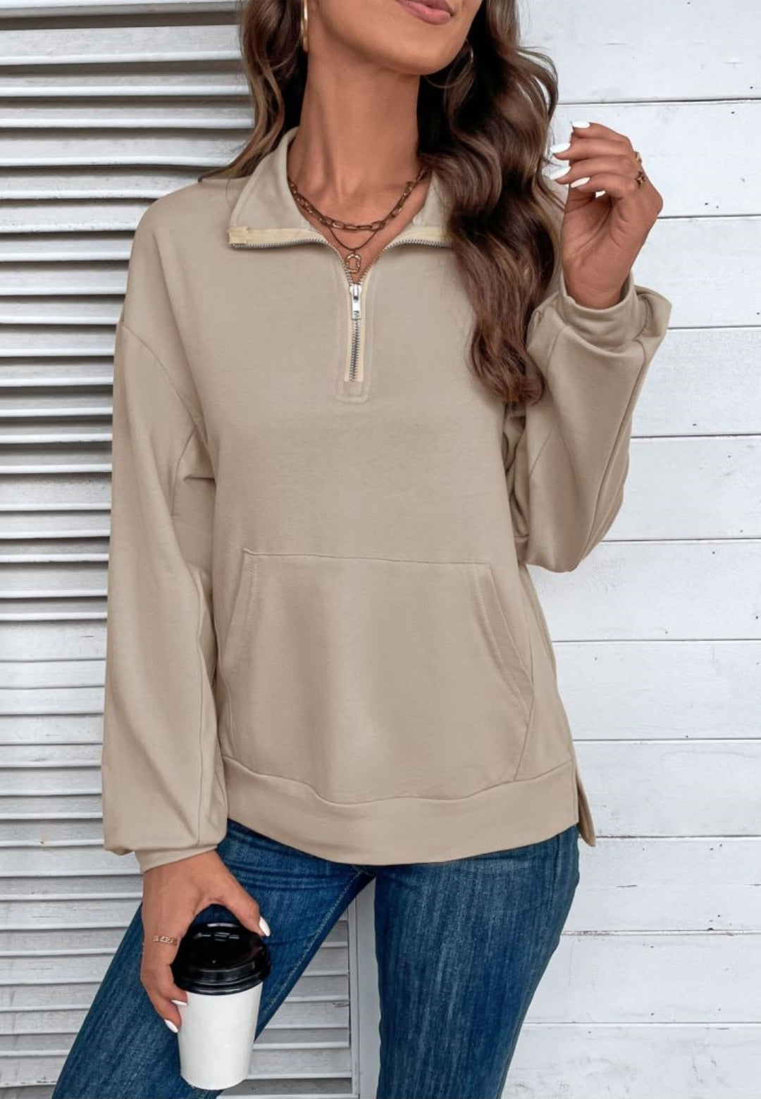 Beige quarter-zip sweatshirt in stretch jersey with a folded point collar, dropped shoulders, and a front kangaroo pocket.