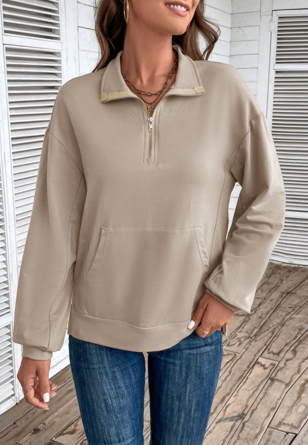 Beige quarter-zip sweatshirt in stretch jersey with a folded point collar, dropped shoulders, and a front kangaroo pocket.