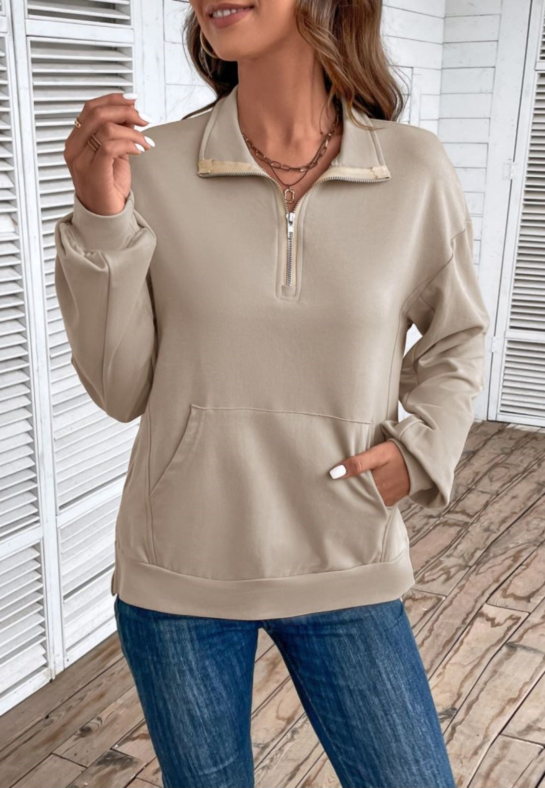 Beige quarter-zip sweatshirt in stretch jersey with a folded collar, dropped shoulders, and a front kangaroo pocket.