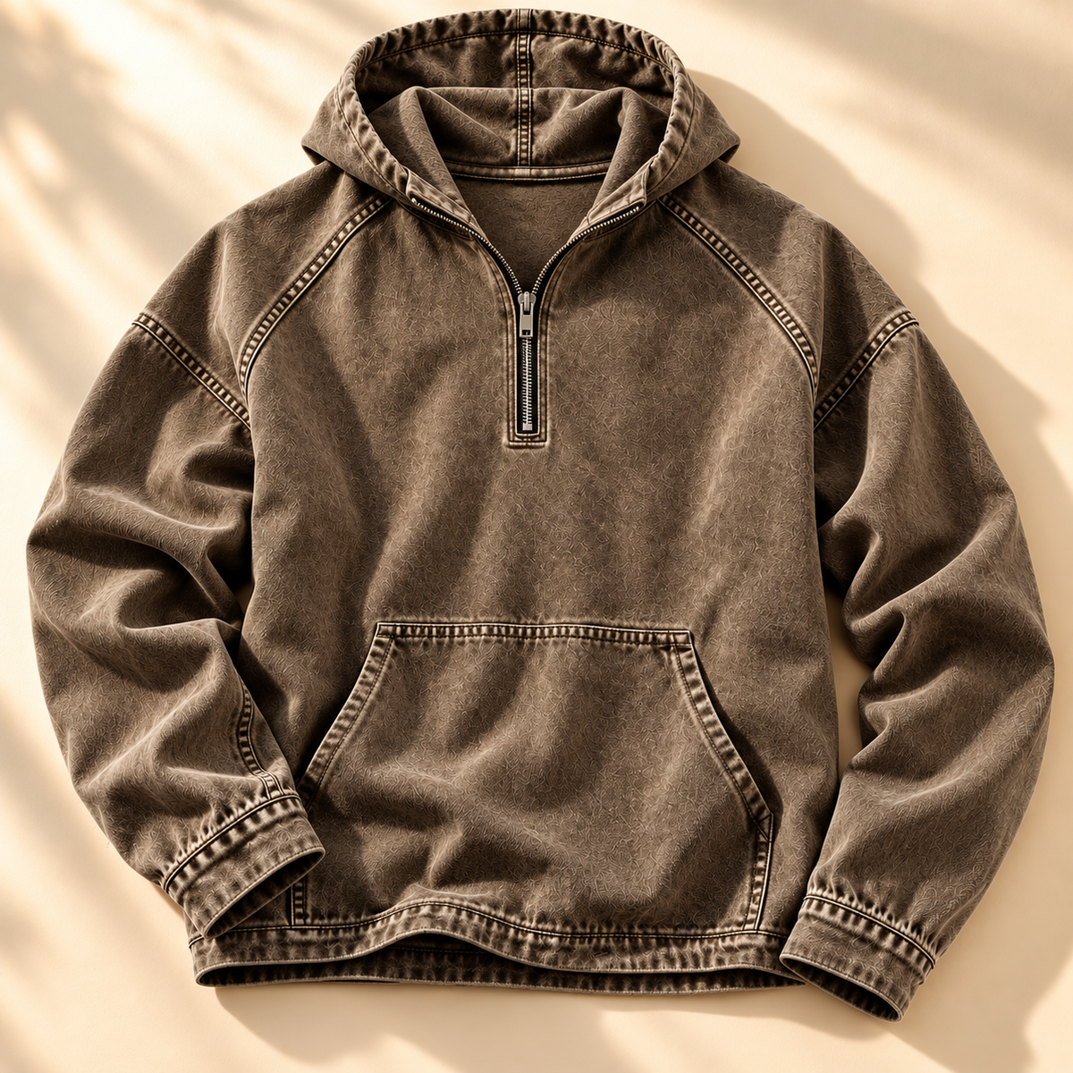 Brown washed half-zip hoodie shown from the front with contrast topstitching and kangaroo pocket.
