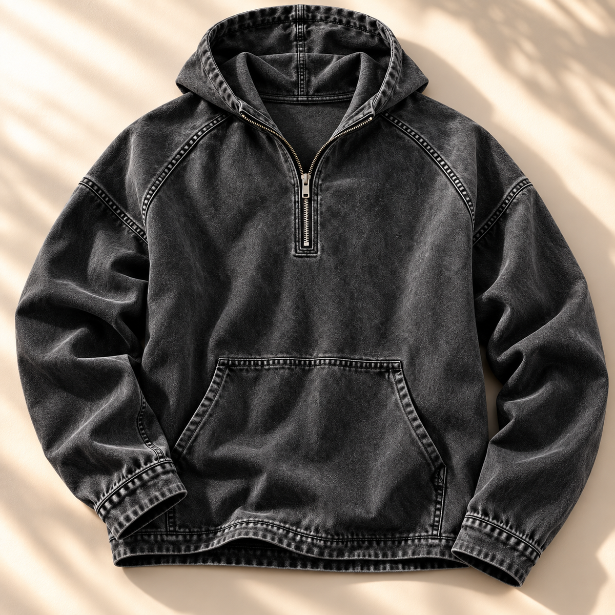Black washed half-zip hoodie shown from the front with contrast topstitching and kangaroo pocket.