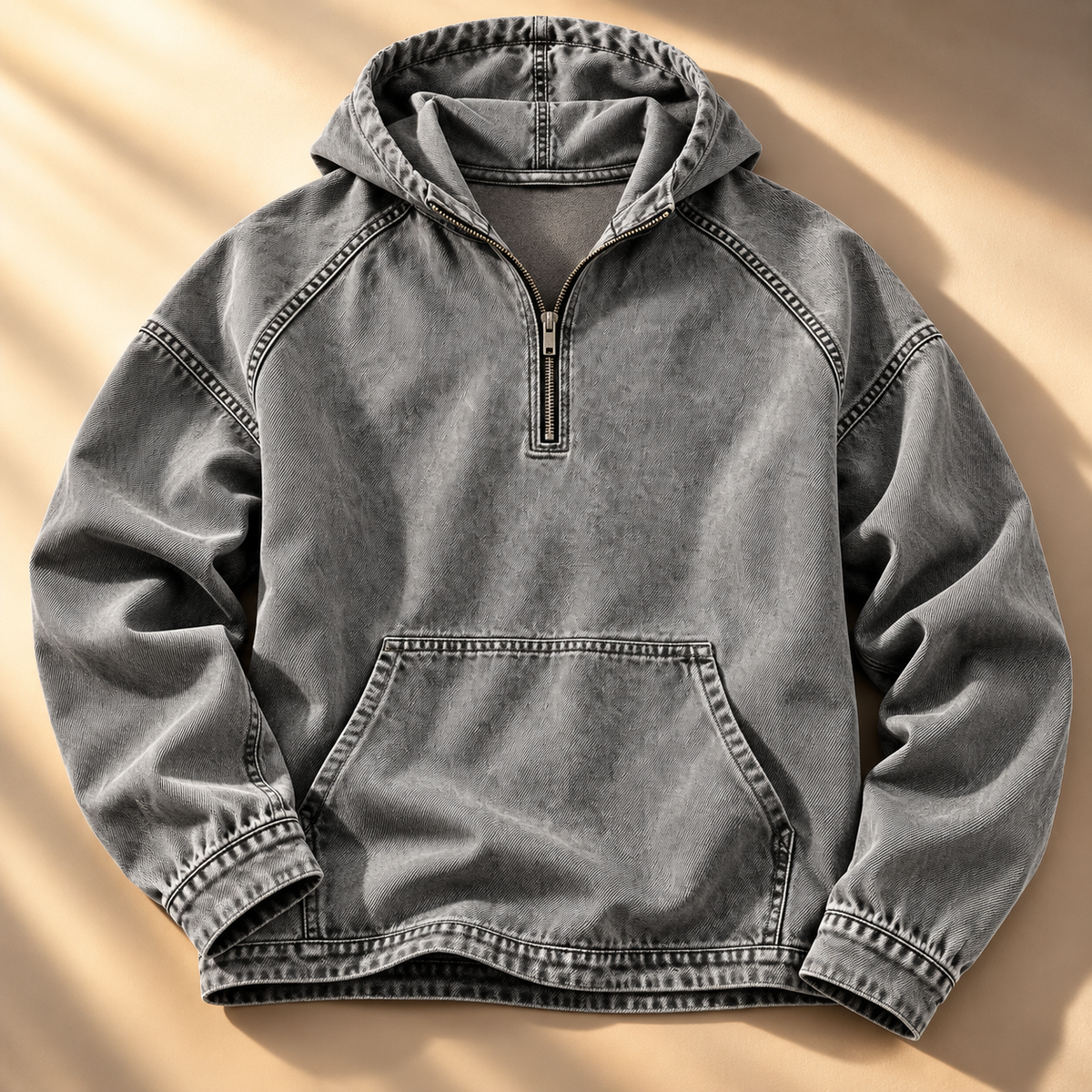 Gray washed half-zip hoodie shown from the front with visible contrast topstitching and kangaroo pocket.