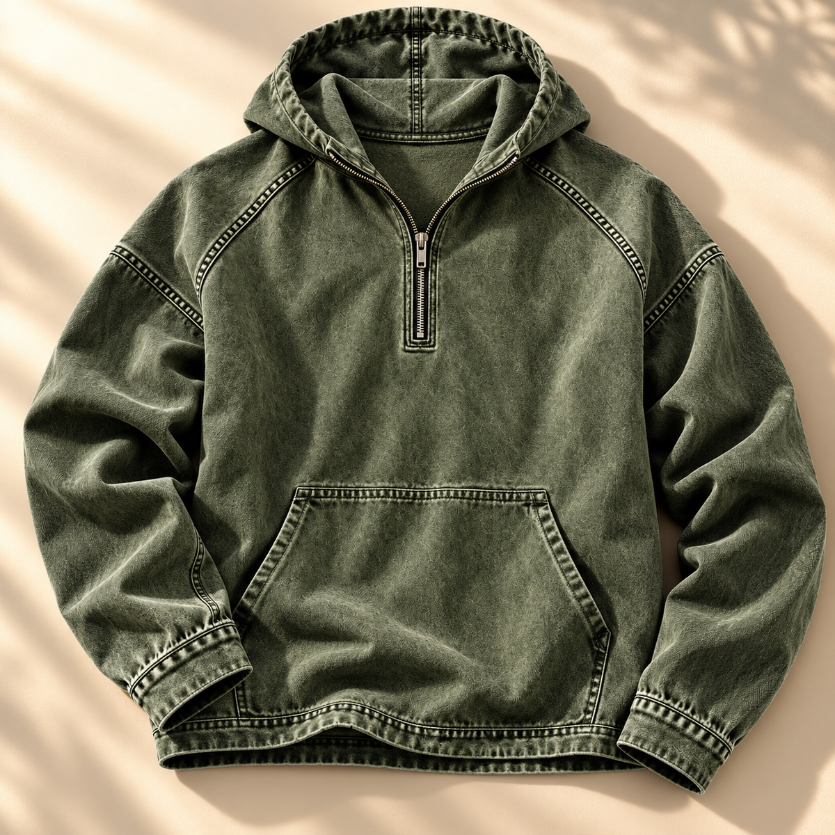 Green washed half-zip hoodie shown from the front with contrast topstitching and kangaroo pocket.