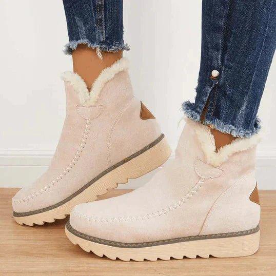 Beige fleece-lined suede ankle boots for women with moc toe stitching, worn with cropped jeans