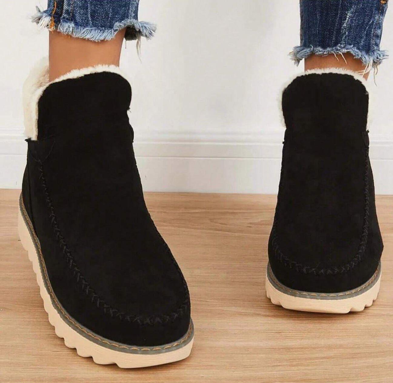 Black pull-on suede ankle boots for women with fleece collar and low treaded sole, worn with jeans