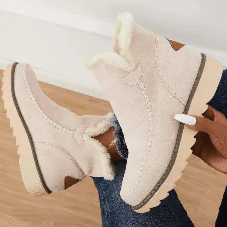 Beige water-repellent suede ankle boots for women showing the fleece lining inside the collar