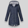 Navy water-resistant parka with a striped hood lining, drawstring waist, and button-tab cuffs on a light grey background.