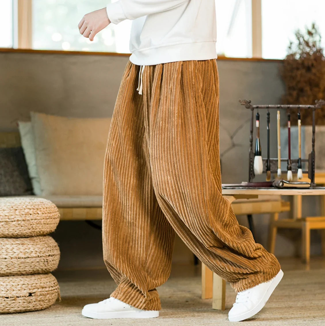 Brown wide-leg corduroy pants styled with a white top and sneakers
