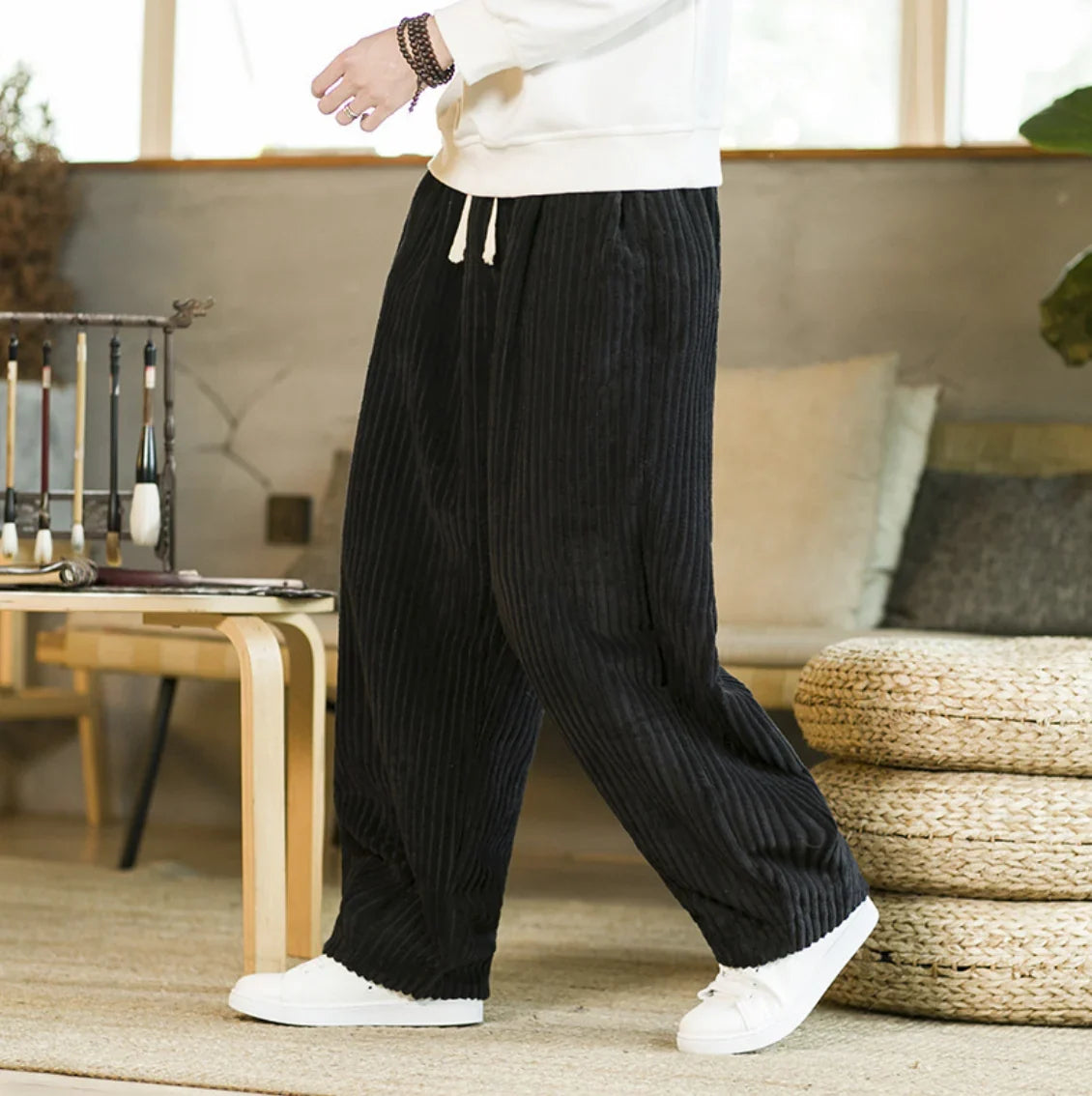 Black wide-leg corduroy pants with elastic drawstring waist and side pockets
