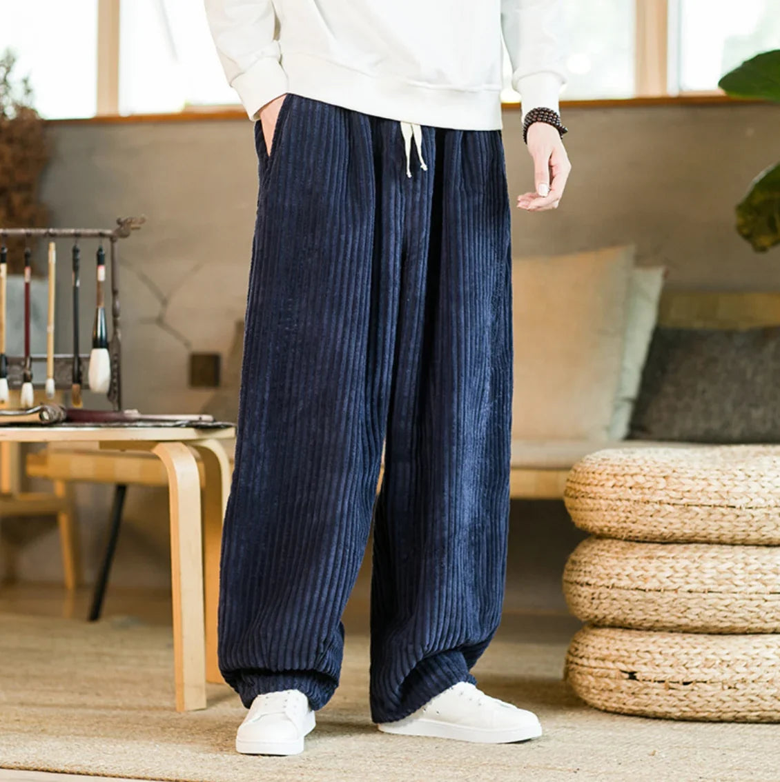 Dark blue wide-leg corduroy pants styled with a white top and sneakers