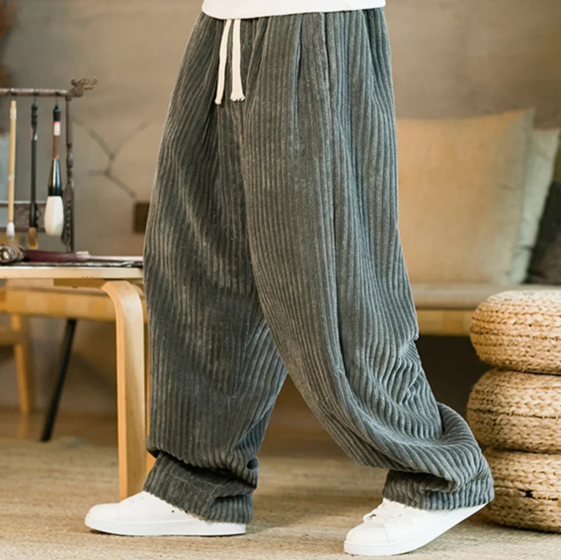 Gray wide-leg corduroy pants shown from the side