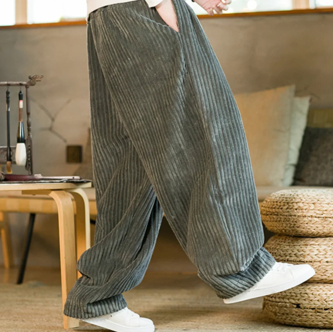 Gray corduroy wide-leg pants shown in a walking pose