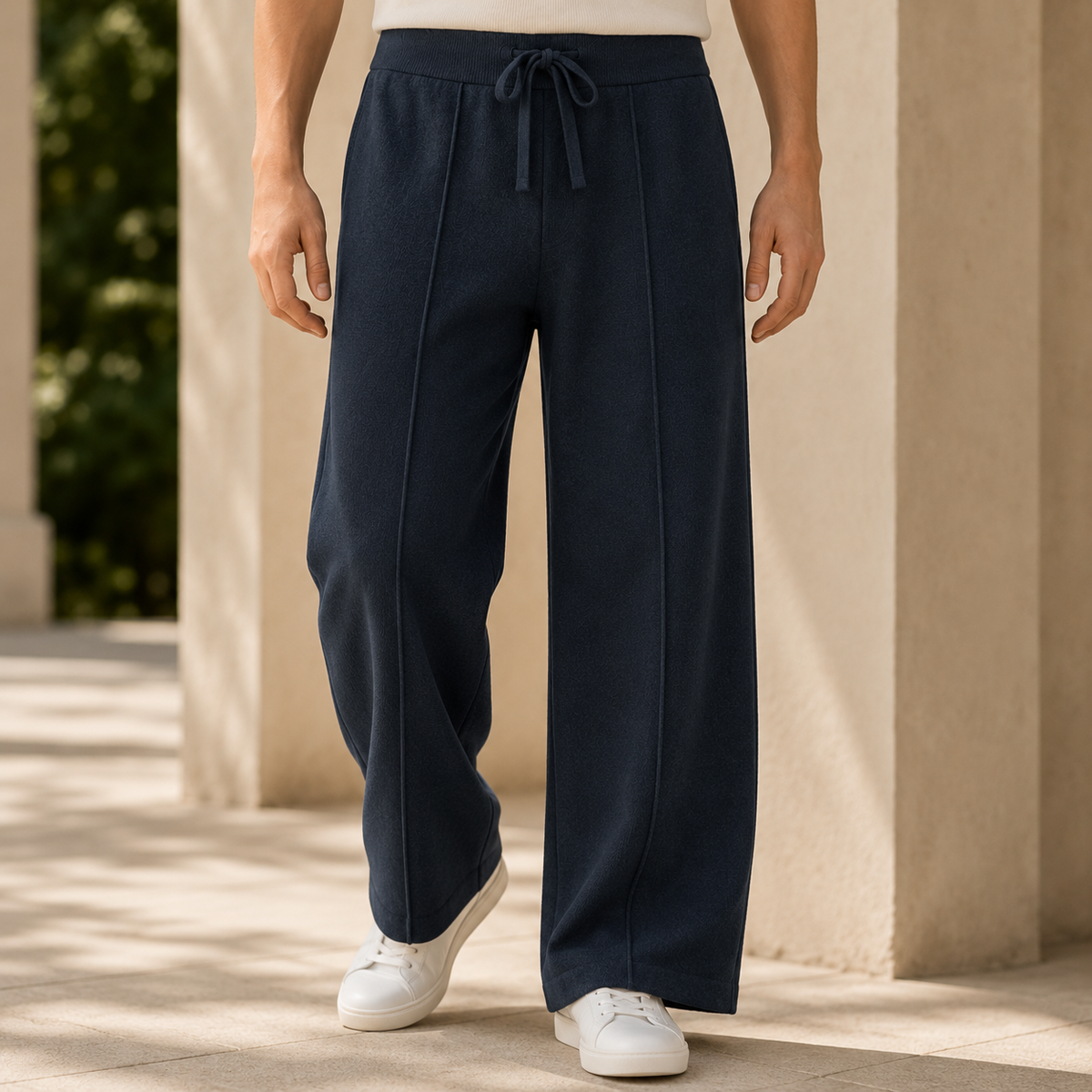 Navy blue wide-leg merino wool pants featuring a ribbed drawstring waist and clean center-seam detailing.