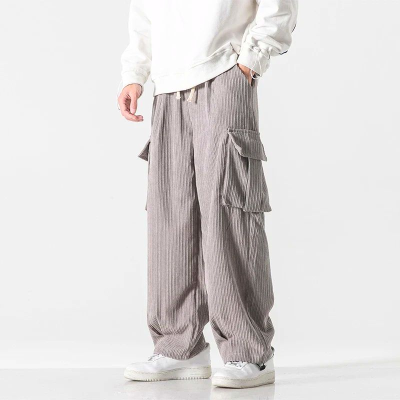 Gray wide-wale corduroy cargo pants with flap thigh pockets and relaxed fit