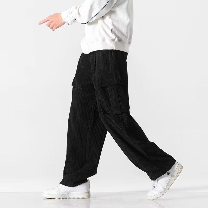 Black wide-leg corduroy cargo pants with flap thigh pockets and drawstring waist