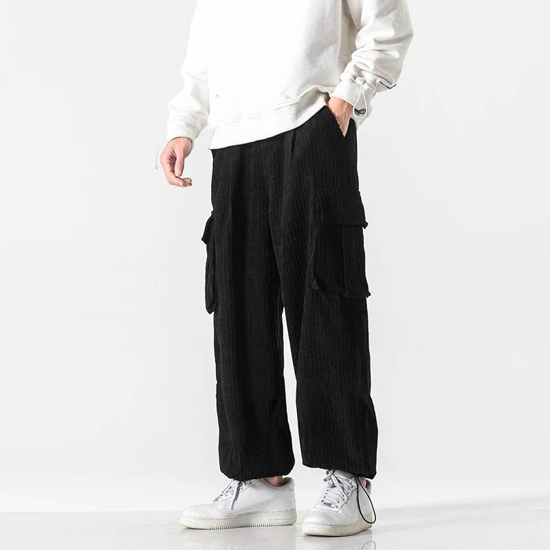 Black corduroy cargo pants shown from the front with relaxed wide-leg fit