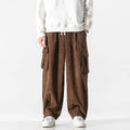 Brown wide-wale corduroy cargo pants with flap thigh pockets and drawstring waist