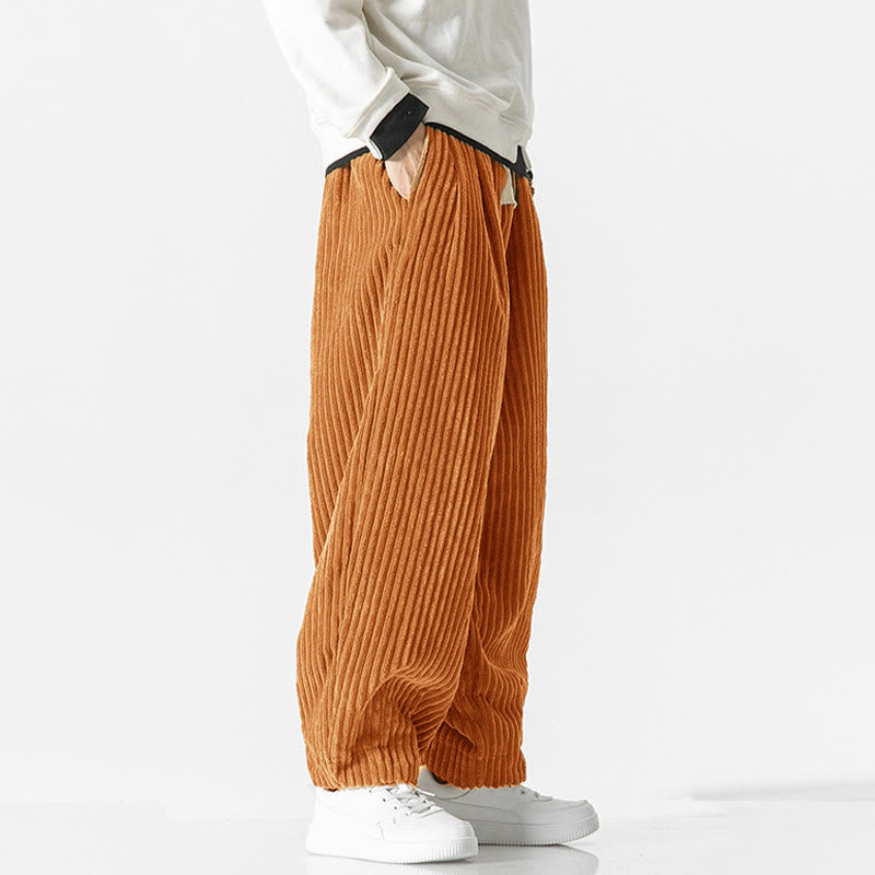 Orange-colored wide-wale corduroy harem pants with a drawstring waist, relaxed fit, and tapered gathered ankles.