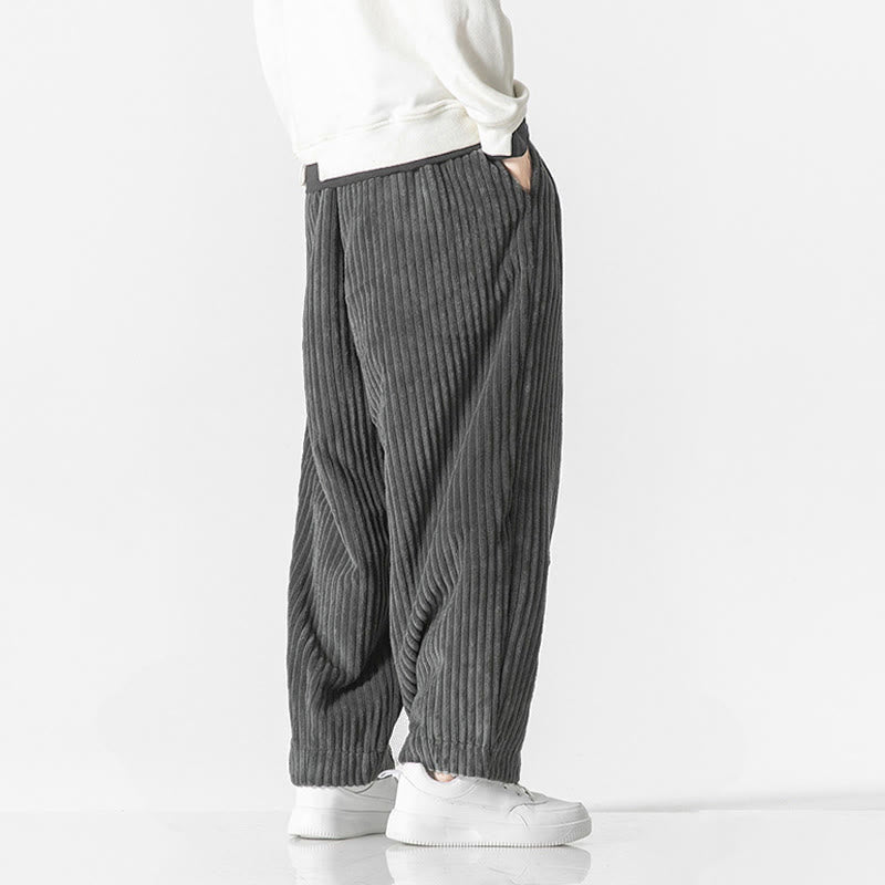 Gray wide-wale corduroy harem pants with a relaxed, tapered fit and elastic drawstring waist worn with white sneakers.