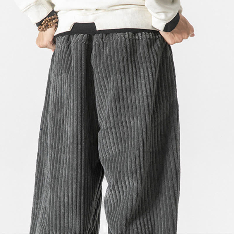 Gray wide-wale corduroy harem pants featuring a relaxed, roomy seat and an elastic drawstring waistband.