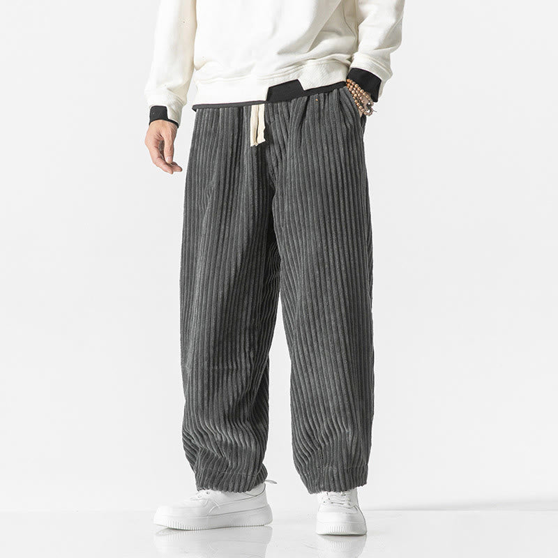 Gray wide-wale corduroy harem pants with a drawstring waist and tapered, gathered ankles.
