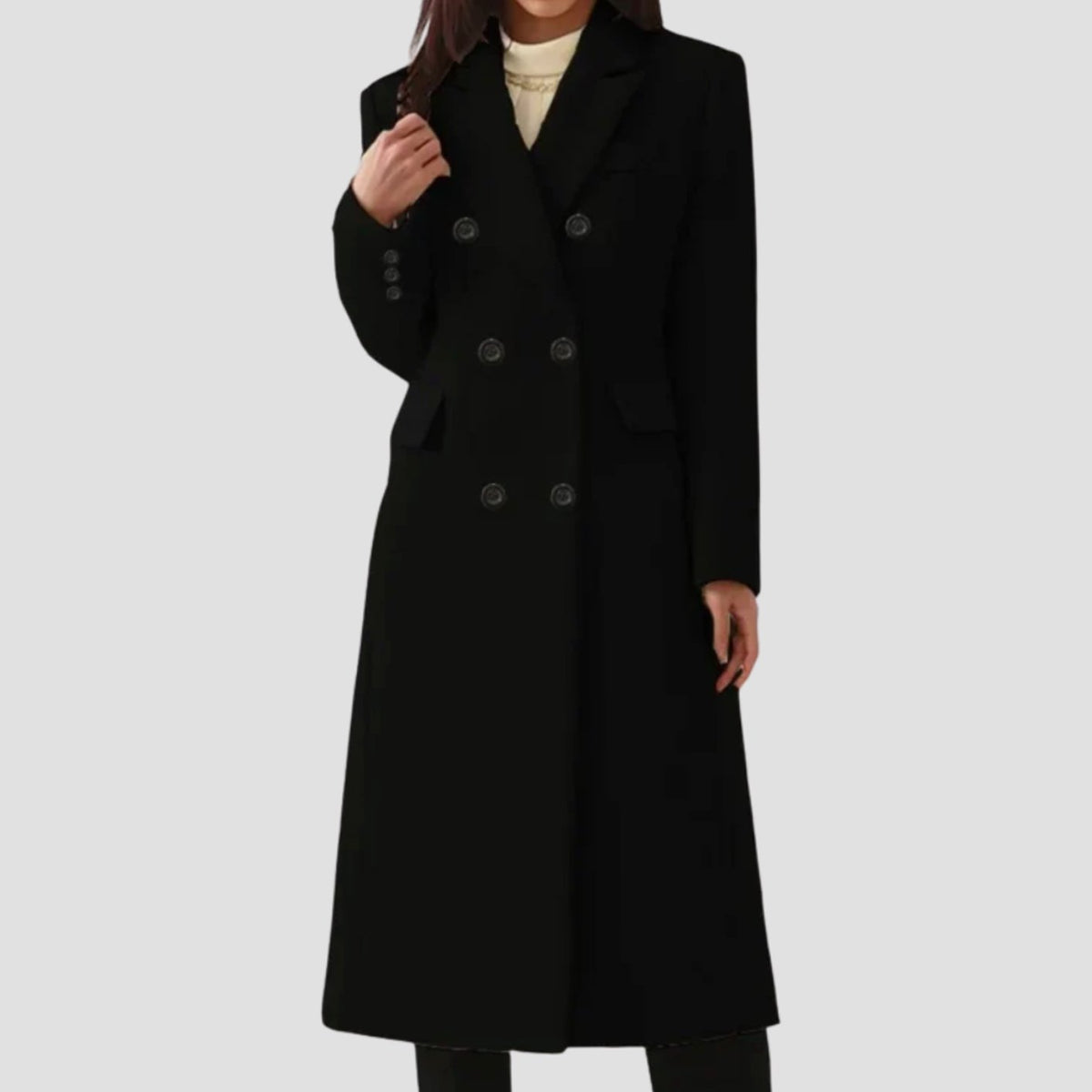 Full-length front view of a woman wearing a classic black double-breasted longline wool-blend coat.