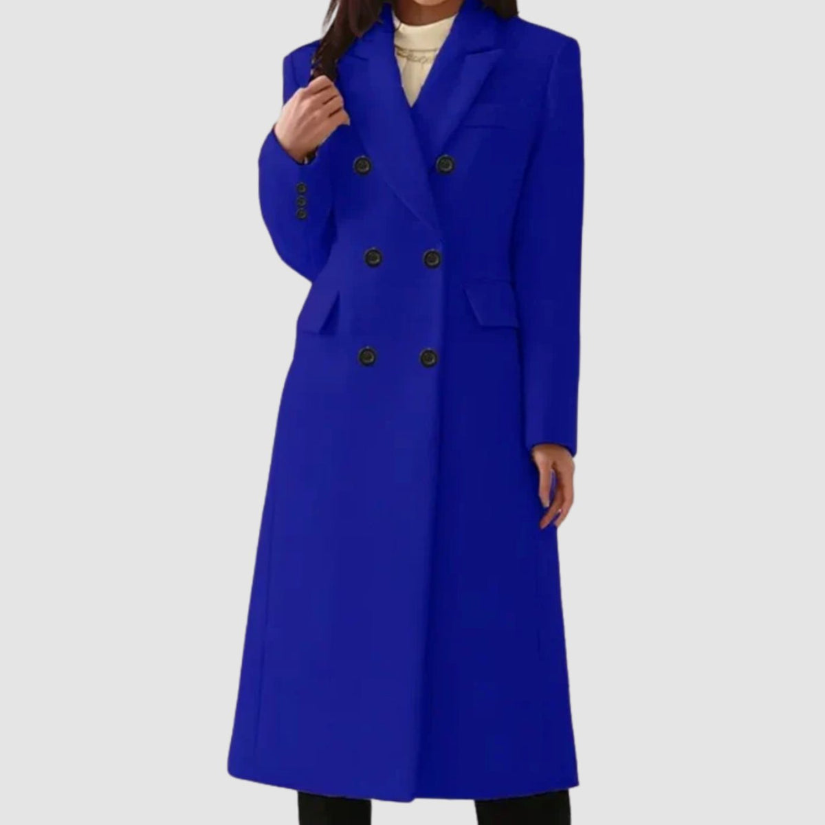 Full-length front view of a woman wearing a vibrant royal blue double-breasted longline coat with black buttons.