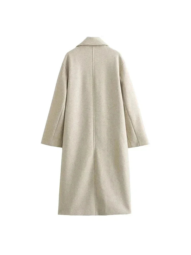 Back view of a beige longline oversized wool coat showing a straight, relaxed silhouette with a center back seam.