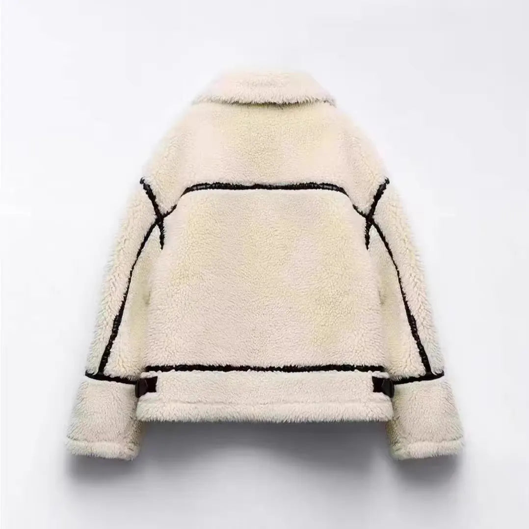 Back view of the cream fleece teddy jacket showing horizontal black contrast leather piping across the shoulders, back, and cuffs.