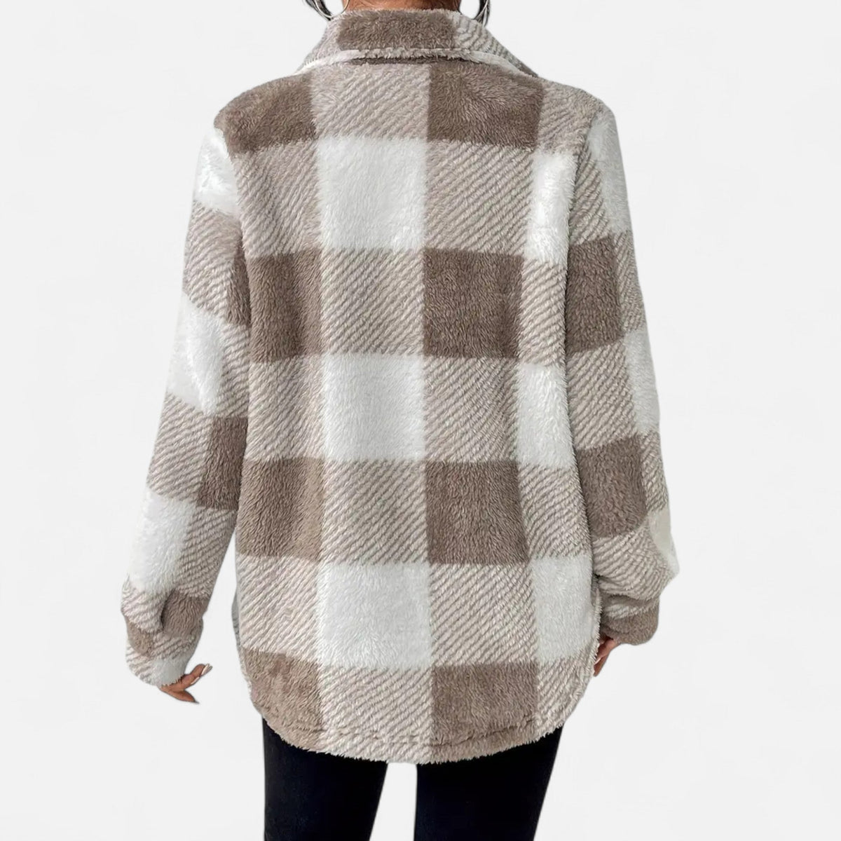 Back view of a woman wearing a gray-and-beige plaid teddy fleece shirt jacket paired with black pants.