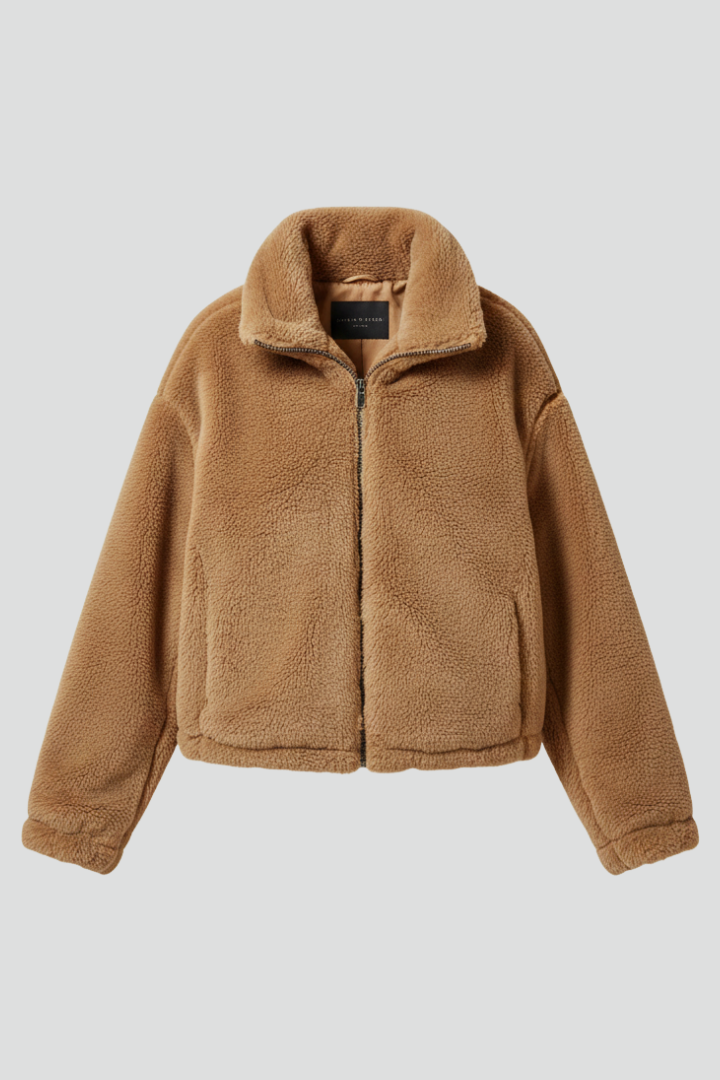 A tan camel-brown women's teddy fleece jacket with a stand collar, zip-front closure, side pockets, and a relaxed fit, isolated against a neutral background.