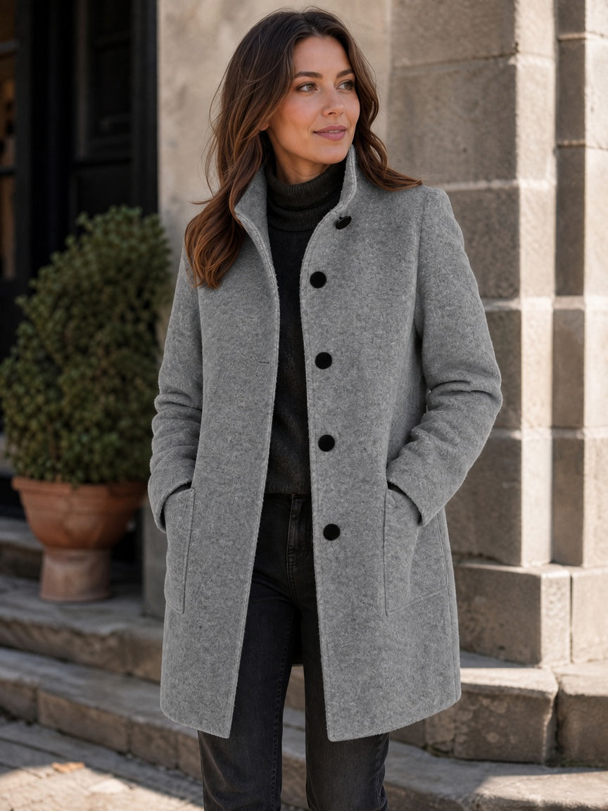 Gray women's coat styled with dark clothing and a straight fit
