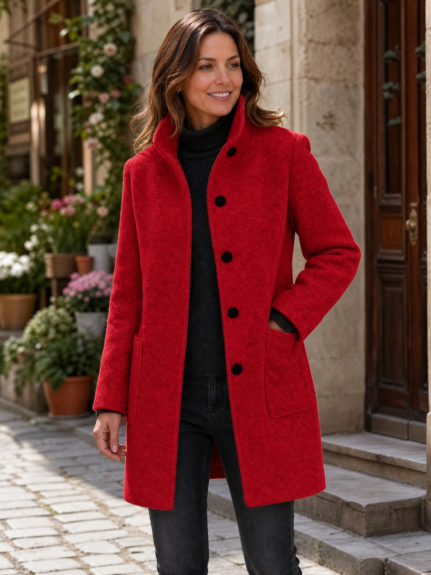 Red wool-blend coat worn by a woman, featuring a button front and patch pockets