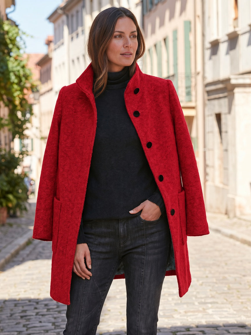 Red women's coat styled with a black outfit, showing the straight silhouette