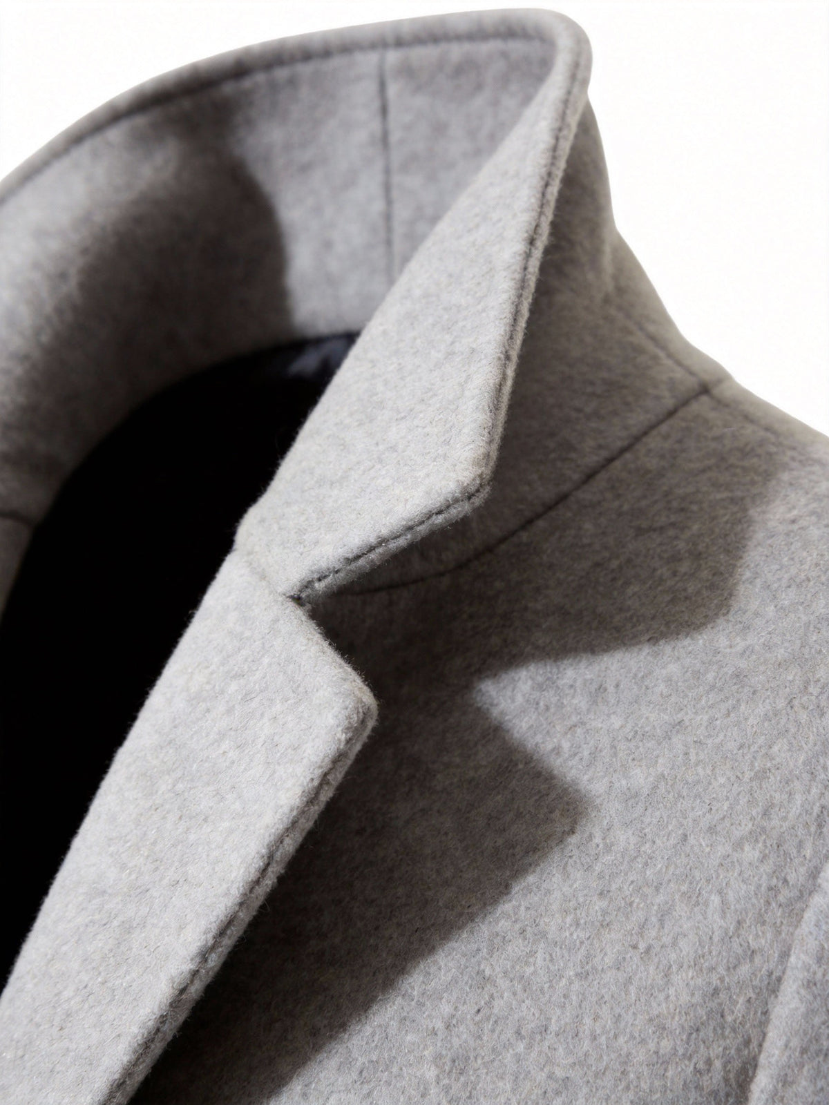 Close-up of the light gray Wool-Blend Longline Trench Coat showing the notch collar and structured lapel detail.