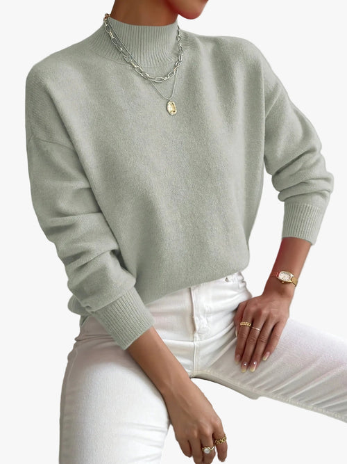 Sage green knit turtleneck sweater featuring a relaxed dropped-shoulder fit, ribbed trim, and soft texture.