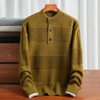 Olive green cotton henley sweater with textured stripe panels, three-button placket, and ribbed trim on a hanger.