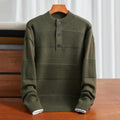 Olive green cotton knit henley sweater with textured stripe panels, a three-button placket, and ribbed trim.