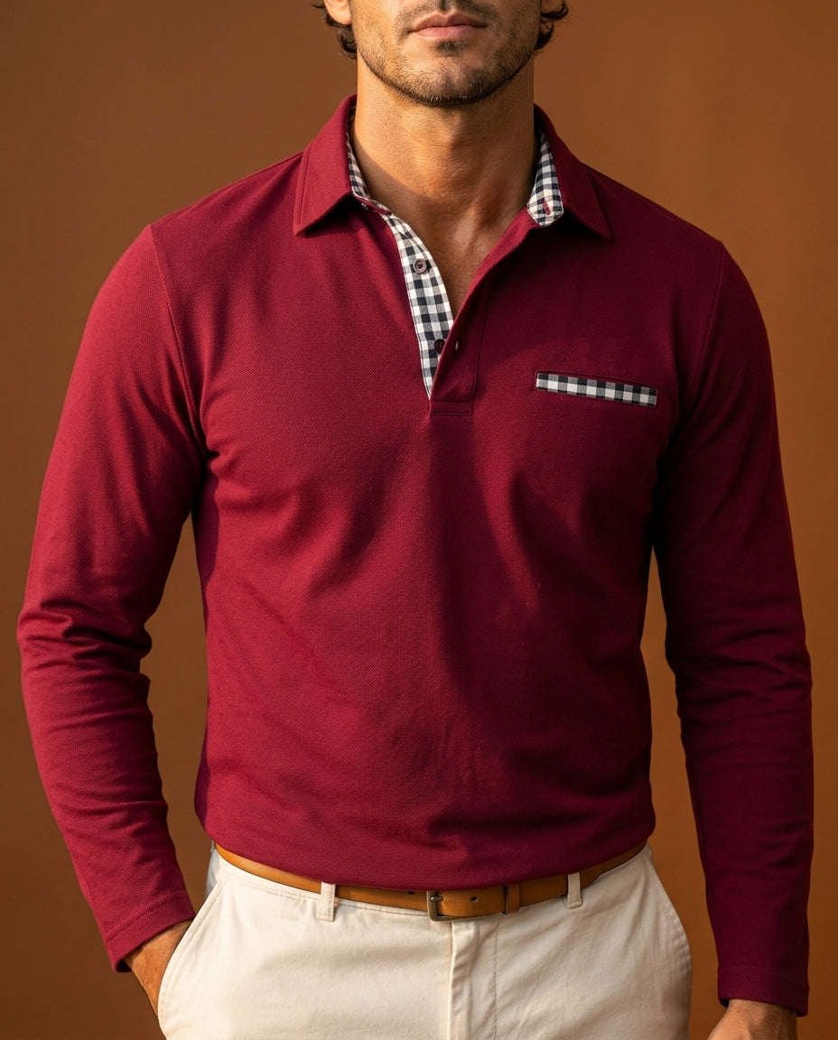 Burgundy long-sleeve pique polo with gingham-trimmed placket and chest pocket, worn with beige trousers.