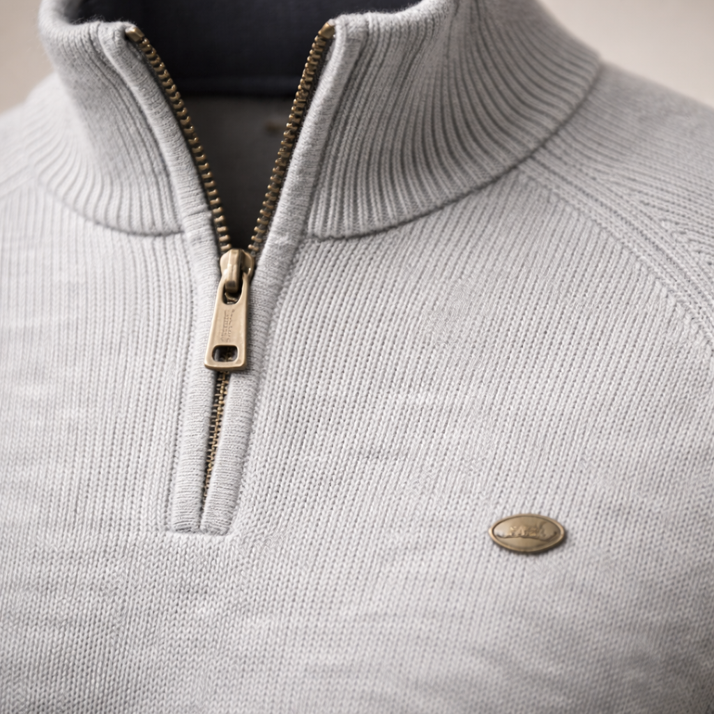 Light grey ribbed knit quarter-zip sweater with a mock neck, raglan sleeves, and a metallic zipper pull.