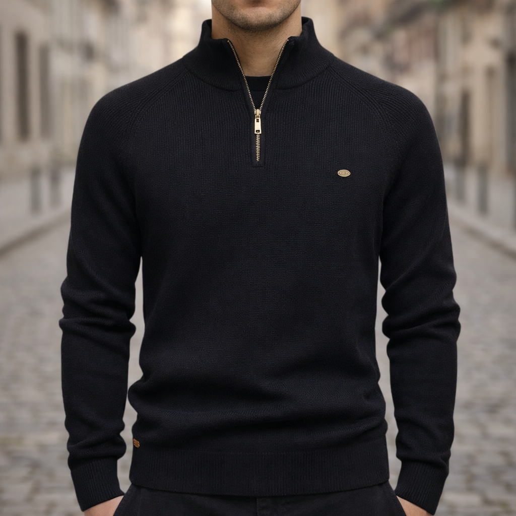 Black ribbed knit quarter-zip sweater with a slim fit, mock neck, and raglan sleeves on a cobblestone street.