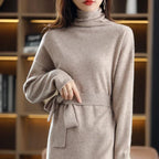 Beige wool midi sweater dress with a high-neck, long sleeves, and a waist-defining tie in a soft knit texture.